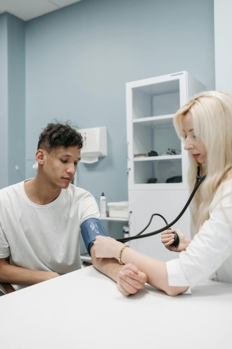 A professional doctor checking a patient's blood pressure in a healthcare clinic.